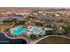 Aerial view of pool, clubhouse, and lake at 17957 W Fairview St, Goodyear, AZ 85338
