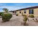 Landscaped backyard with gravel, bushes and a patio at 17957 W Fairview St, Goodyear, AZ 85338