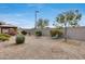 Backyard with gravel, small bushes, and a table and chairs at 17957 W Fairview St, Goodyear, AZ 85338
