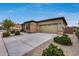 Two-car garage with driveway and desert landscaping at 17957 W Fairview St, Goodyear, AZ 85338