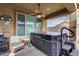 Covered patio with hot tub, comfortable seating, and ceiling fan at 17957 W Fairview St, Goodyear, AZ 85338