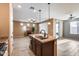 Kitchen island with granite countertops and view into living room at 17957 W Fairview St, Goodyear, AZ 85338