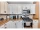 Kitchen features gas range, microwave, and granite countertops at 17957 W Fairview St, Goodyear, AZ 85338