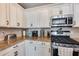 Kitchen features gas range, microwave, and granite countertops at 17957 W Fairview St, Goodyear, AZ 85338