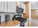 Kitchen features gas range, microwave, and granite countertops at 17957 W Fairview St, Goodyear, AZ 85338