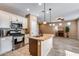 Open kitchen with island, stainless steel appliances, and granite countertops at 17957 W Fairview St, Goodyear, AZ 85338