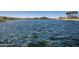 Calm lake view with distant hills and palm trees at 17957 W Fairview St, Goodyear, AZ 85338