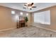 Living room with fireplace, ceiling fan and large window at 17957 W Fairview St, Goodyear, AZ 85338