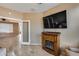 Living area with fireplace, TV and view into adjacent room at 17957 W Fairview St, Goodyear, AZ 85338