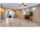Living room with fireplace, ceiling fan and view to kitchen at 17957 W Fairview St, Goodyear, AZ 85338