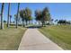 Paved walkway meandering through grassy landscape at 17957 W Fairview St, Goodyear, AZ 85338