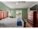 Relaxing bedroom with wooden bed frame, dresser, and view of the backyard at 18235 N 129Th Dr, Sun City West, AZ 85375