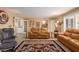 Spacious living room featuring comfortable leather furniture and southwestern decor at 18235 N 129Th Dr, Sun City West, AZ 85375