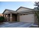 Single-story home with neutral exterior and two-car garage at 21231 E Domingo Rd, Queen Creek, AZ 85142