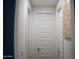 Hallway with neutral walls and white doors at 21231 E Domingo Rd, Queen Creek, AZ 85142