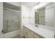 Updated bathroom with a white vanity, new flooring, and a glass shower enclosure at 2717 E Cinnabar Ave, Phoenix, AZ 85028