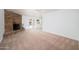 Living room with brick fireplace, carpet, and sliding door access to backyard at 2717 E Cinnabar Ave, Phoenix, AZ 85028