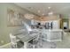 Open concept kitchen with white cabinets, quartz counters, and breakfast bar at 3145 E Desert Ln, Gilbert, AZ 85234