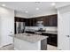 Modern kitchen with dark cabinets and granite countertops at 3718 S 58Th Dr, Phoenix, AZ 85043