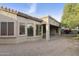 Exterior view showcasing the home's architecture with multiple windows, stucco finish and a covered patio at 4168 E Walnut Rd, Gilbert, AZ 85298