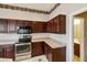 Close-up view of kitchen with dark cabinets, stainless steel appliances at 4168 E Walnut Rd, Gilbert, AZ 85298