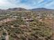 Aerial view of a house with a pool, surrounded by desert vegetation at 44821 N 12Th St, New River, AZ 85087