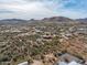 Aerial view of a house with a pool, surrounded by desert landscape and mountains at 44821 N 12Th St, New River, AZ 85087