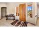 Entryway with tile flooring, wooden door, and views of the desert at 44821 N 12Th St, New River, AZ 85087