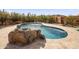 Inviting kidney-shaped pool with large rocks and paved patio at 44821 N 12Th St, New River, AZ 85087