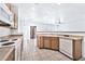 Kitchen with wood cabinets, island, white appliances, and tile floor at 518 N 112Th Dr, Avondale, AZ 85323