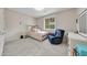 Charming bedroom with a comfortable bed, recliner chair, and ample space at 650 E Colter St, Phoenix, AZ 85012