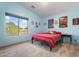 Bedroom featuring a red striped bed and large window at 7727 S 22Nd Ln, Phoenix, AZ 85041