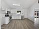 Modern kitchen with white cabinets, stainless steel appliances, and tile floors at 9322 E Des Moines St, Mesa, AZ 85207