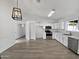 Kitchen with stainless steel appliances and a modern chandelier at 9322 E Des Moines St, Mesa, AZ 85207