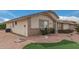 Side view of the house showcasing its brick exterior and landscaping at 11439 E Mendoza Ave, Mesa, AZ 85209