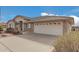 Front view of the house with a two-car garage and neatly landscaped yard at 11439 E Mendoza Ave, Mesa, AZ 85209