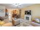 Open living room with a neutral color scheme, fireplace, and adjacent kitchen at 12635 N La Montana Dr # 8, Fountain Hills, AZ 85268