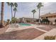 Community pool with surrounding patio and palm trees at 12635 N La Montana Dr # 8, Fountain Hills, AZ 85268