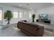 Bright living room with tiled floors and a stylish brown couch at 14851 S 179Th Ave, Goodyear, AZ 85338