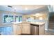 Modern white kitchen with stainless steel appliances and an island at 15553 W Ventura St, Surprise, AZ 85379