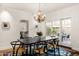 Bright dining room with chandelier, patio access, and modern table at 1603 Palmcroft Se Dr, Phoenix, AZ 85007