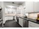 Modern kitchen with white cabinets, dark counters, and stainless steel appliances at 1603 Palmcroft Se Dr, Phoenix, AZ 85007