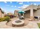 Spacious backyard with a fire pit, outdoor kitchen, and patio furniture at 1998 W Fruit Tree Ln, Queen Creek, AZ 85144