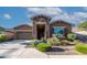 Single story home with stone accents and a two-car garage at 2466 N 212Th Ln, Buckeye, AZ 85396