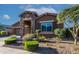 House exterior with stone accents and landscaped front yard at 2466 N 212Th Ln, Buckeye, AZ 85396