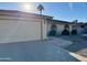 Single-story home with a two-car garage and landscaped yard at 25620 S Cloverland Dr, Sun Lakes, AZ 85248