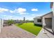 Artificial turf backyard with gravel and mature trees at 2860 N Riverdale Ln, Casa Grande, AZ 85122