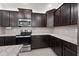Dark wood cabinets and granite countertops in this kitchen at 2860 N Riverdale Ln, Casa Grande, AZ 85122