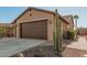 Tan house with brown garage door and desert landscaping at 4645 W Loma Verde Ave, Eloy, AZ 85131