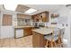 Kitchen with wood cabinets, a breakfast bar, and appliances at 4736 W Marconi Ave, Glendale, AZ 85306